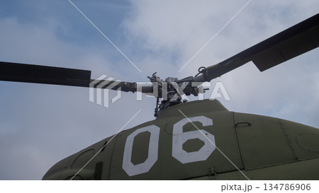low-angle helicopter rotor hub with painted number 06, heavy rotor blades, central mast and linkage low-angle helicopter rotor hub with painted number 06, heavy rotor blades, central mast and linkage 134786906