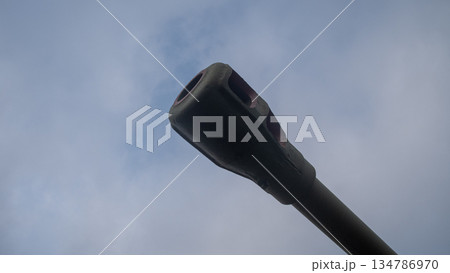 tank muzzle overlooking green tent encampment, visible barrel end above canvas shelters and tree line, 134786970