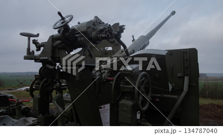 exposed gunner controls cluttered with wheels and levers, handwheels and sight components form intricate 134787040