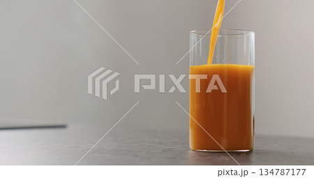 sea buckthorn juice pour into beaker glass on concrete surface sea buckthorn juice pour into beaker glass on concrete surface 134787177