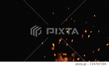 sparks and embers from campfire flying over black background sparks and embers from campfire flying over black background 134787194