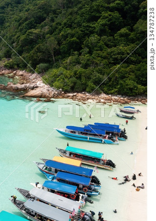 Tourist boats parked along turtle beach, with tourists on Redang Island. Malaysia Tourist boats parked along turtle beach, with tourists on Redang Island. Malaysia 134787238