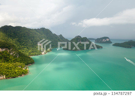 Stunning aerial view of emerald waters and lush islands in a tropical paradise at KILIM Geopark on Langkawi Island. Malaysia Stunning aerial view of emerald waters and lush islands in a tropical paradise at KILIM Geopark on Langkawi Island. Malaysia 134787297