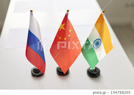 Desk flags for diplomacy on conference table, symbols of trilateral cooperation Desk flags for diplomacy on conference table, symbols of trilateral cooperation 134788205