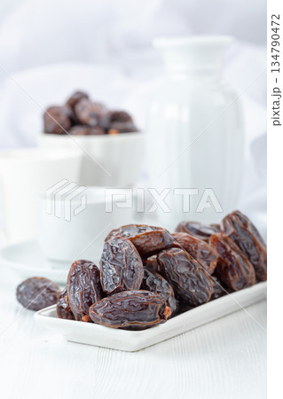 Dried medjool dates on a white table. 134790472