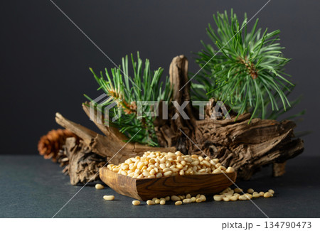 Peeled pine nuts with cedar dried snags and green branches. 134790473