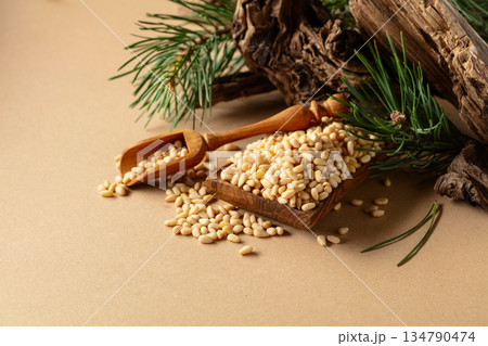 Peeled pine nuts with cedar snags and green branches. 134790474