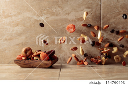 Mix of dried fruits and nuts in motion. Mix of dried fruits and nuts in motion. 134790498