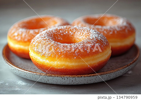 Baking marketing. Glazed yellow donuts. Donuts on a ceramic  plate on a white background. Sweet topping food. 134790959