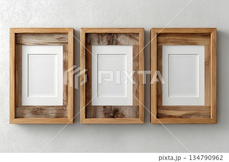 Neutral tones. Simple design. Mock up for modern interior and branding. Empty wooden photo frame for a collage of three photos in a minimalist style on a white background. Stylish photo frame. 134790962