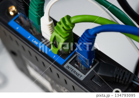 Colorful Ethernet Cables Connected to a Router. Colorful Ethernet Cables Connected to a Router. 134793095