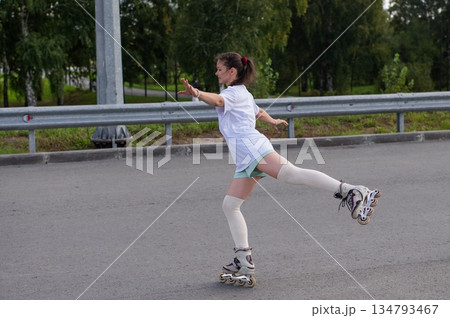 Caucasian woman rollerblading fast on road.  134793467