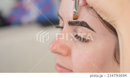 Caucasian woman getting eyebrow tinting procedure.  134793694