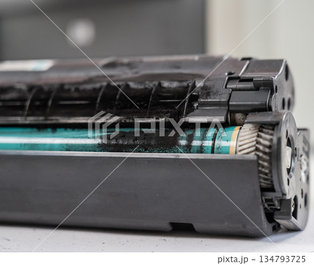 Broken laser printer cartridge on white background.  134793725