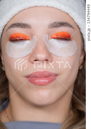 Caucasian woman undergoing eyelash lamination procedure. top view.  134794449