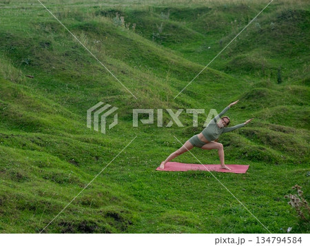 Caucasian woman doing yoga outdoors. Caucasian woman doing yoga outdoors. 134794584