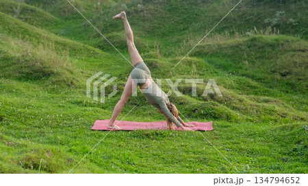Caucasian woman doing yoga outdoors.  134794652