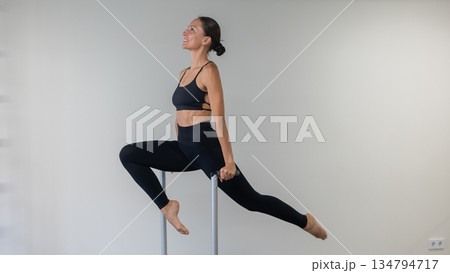Caucasian woman doing Pilates on classic chair. Caucasian woman doing Pilates on classic chair. 134794717