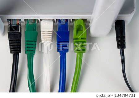 Colorful Ethernet Cables Connected to a Router.  134794731