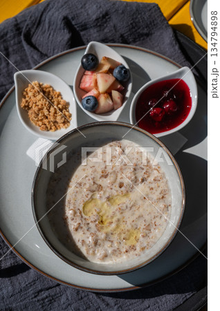 Reserved breakfast at a cafe. A plate of porridge on a table in a street cafe.  134794898