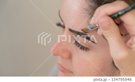 Caucasian woman getting eyebrow tinting procedure.  134795046