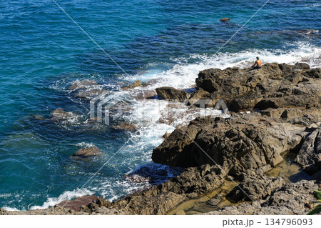 Rocky coastline with waves in Cefalu, Sicily 134796093