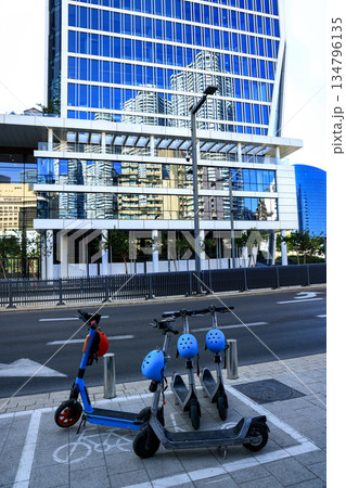 Electric scooters and modern glass building in Tel Aviv 134796135