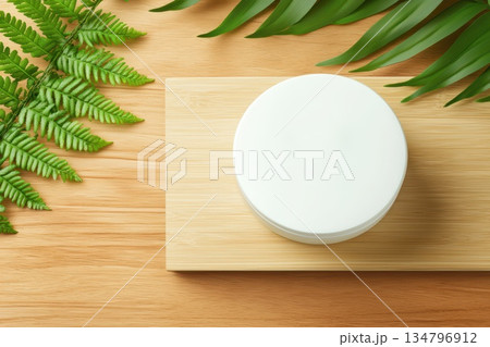 Minimalist Biodegradable Container on Wooden Surface with Green Leaves Surrounding 134796912