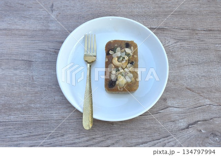 butter banana cake topping peanut and whole grain couple raisin with golden fork on plate 134797994