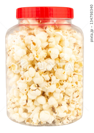 Popcorn in a clear plastic jar isolated on white background 134798340
