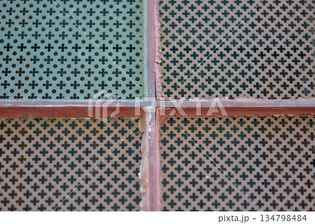 Rusty Metal Grid with Plus-Shaped Holes Pattern Textured Background Rusty Metal Grid with Plus-Shaped Holes Pattern Textured Background 134798484