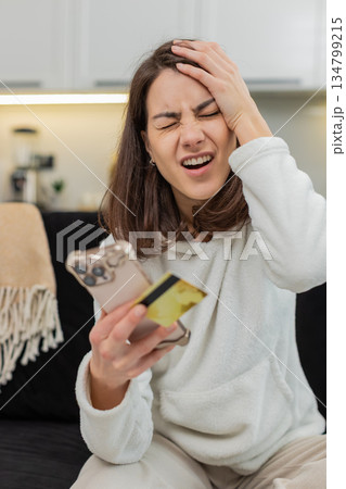 Young woman sees payment fail on smartphone blocked card suspected fraud panics calls support help Young woman sees payment fail on smartphone blocked card suspected fraud panics calls support help 134799215