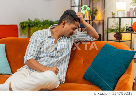 Indian man tired and bad mood after hard day stress fatigue burnout needs rest quiet time and calm 134799235