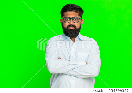 Indian man crossing arms looking strict showing authority confidence discipline serious emotion Indian man crossing arms looking strict showing authority confidence discipline serious emotion 134799337