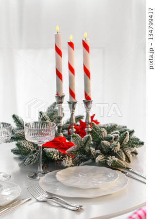 Elegant crystal tall glass with festive evergreen decor for Christmas holiday dinner Elegant crystal tall glass with festive evergreen decor for Christmas holiday dinner 134799417