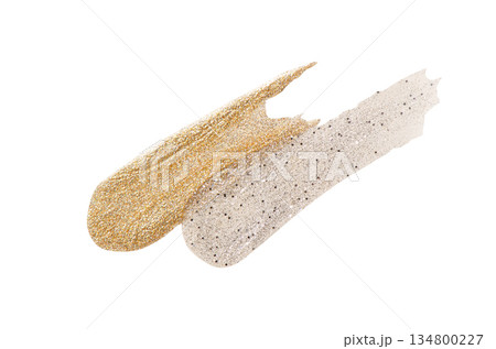 A sample of silver and gold nail polish with a shimmer and metallic effect. Isolated on a white background. 134800227