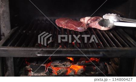 Steakhouse. Steaks are roasted on a Josper oven. Frying a steak on a josper. Steakhouse. Steaks are roasted on a Josper oven. Frying a steak on a josper. 134800427
