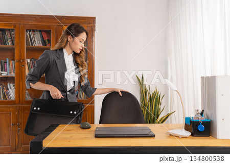 Confident professional woman gathers items before leaving office 134800538