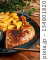 Crispy roasted chicken leg with french fries. 134801820