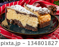 Two pieces of cheesecake. 134801827