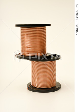 Copper coils on a white background. Copper wire for electronics. Pure copper. 134802069