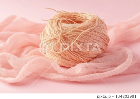 Crafting with soft yarn and delicate fabric on a pink surface 134802981