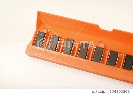 Microchips in a plastic case. Integrated circuits in a plastic storage case. Electronic chips. 134803808