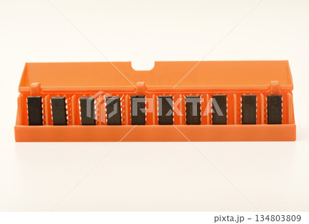 Microchips in a plastic case. Integrated circuits in a plastic storage case. Electronic chips. Microchips in a plastic case. Integrated circuits in a plastic storage case. Electronic chips. 134803809