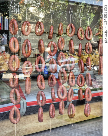 traditional butcher shop with original decor of hanging sausage rings 134803855