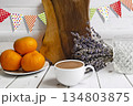 White cup of coffee and glass with oranges and lavender 134803875