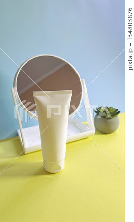 White cosmetic tube in front of mirror White cosmetic tube in front of mirror 134803876