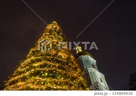Christmas tree of the country near St. Sophia Cathedral. Christmas lights at night sky. Bell tower. 25 December 2025 Christmas tree of the country near St. Sophia Cathedral. Christmas lights at night sky. Bell tower. 25 December 2025 134804010