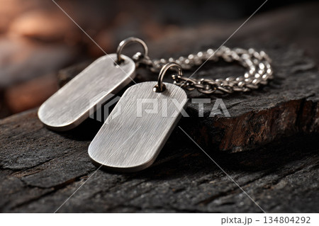 Soldier dog tags rest on rugged wooden background, symbolizing military identity and service with sense of honor and remembrance Soldier dog tags rest on rugged wooden background, symbolizing military identity and service with sense of honor and remembrance 134804292