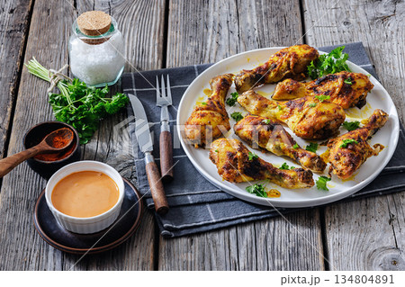 roasted chicken drumsticks on a white plate 134804891